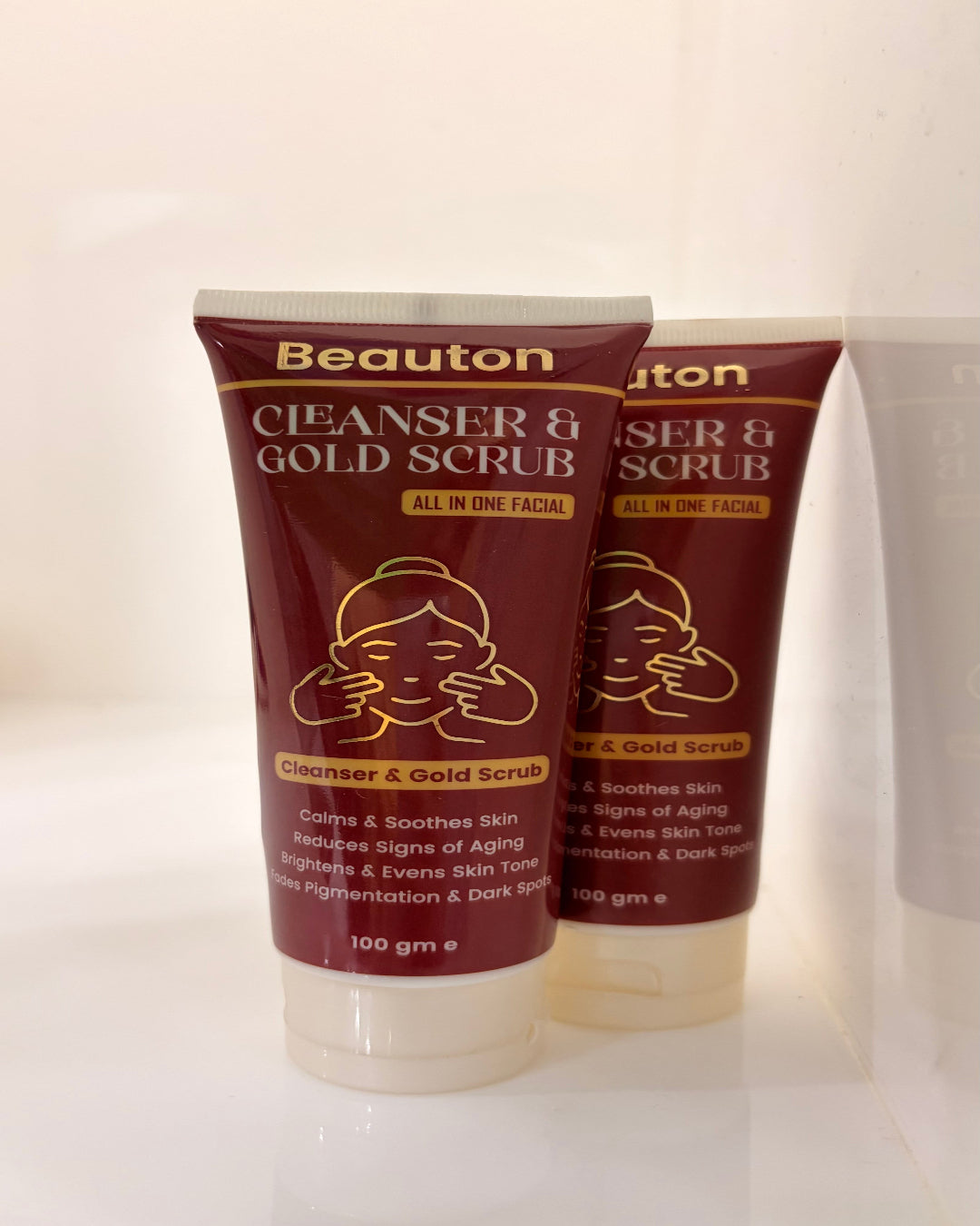 Two tubes of Beauton Cleanser & Gold Scrub on a white background