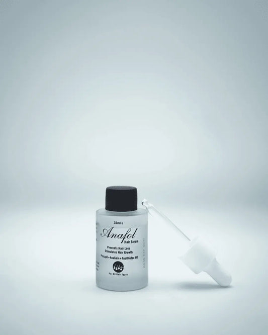 Anafol Hair Serum being massaged into scalp and hair, showing its non-rinse formula that combats hair fall and promotes density and growth.